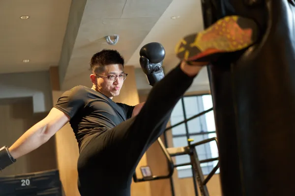 asian-man-kicking-a-punching-bag-2025-03-15-23-52-45-utc-6914ab1a7e8a5